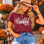 Thankful Tee - model standing on fall porch, beige fedora